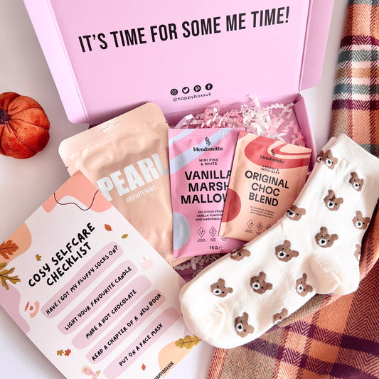 Image of a open Happy Boxx with items laid out on a cosy autumn colour blanket