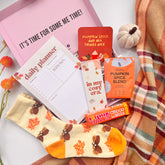 Autumn themed items including Autumn socks, Autumn themed planner and pumpkin spice products on a textured surface.